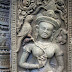 The crown on Sikhoraphum's north devata is also a different style from those seen at Angkor Wat. Interestingly, it is similar to the crown on one of the *only* other devata seen outside of Cambodia - a sacred woman depicted at Wat Phu in Laos. Again, the animals are unique. While perhaps a dozen women at Angkor Wat have birds (out of 1,780) none are depicted with squirrels (one has a small dog). Also, none of the birds at Angkor Wat are this large. Read the full story on http://www.devata.org