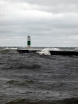 Keith Wikle barely visible in this shot of the North side of the river mouth in his Nigel Foster Silhouette on Lake Michigan. This was a sizeable storm, 25-30 knot winds, and 8-10 foot waves. http://keithwikle.com