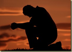man praying on one knee
