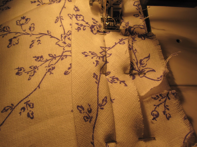 Using the zipper foot to sew the piping on to the bottom of the bodice Using the zipper foot to sew the piping on to the bottom of the bodice