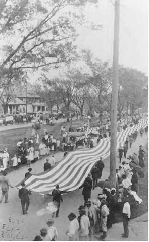 Preparedness Day Parade in Baton Rouge, Louisiana, 1916, featuring a 300-foot-long American flag. Note the rigidly-segregated bystanders: whites on the left; blacks on the right. 