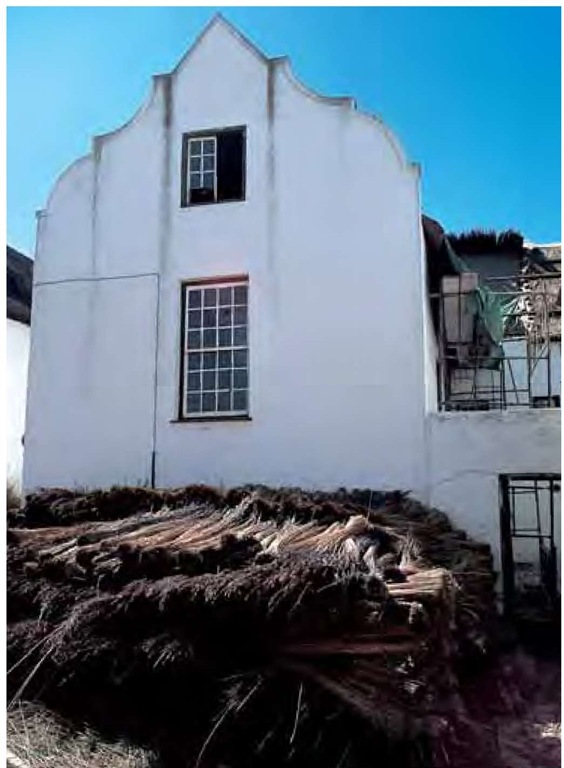 Locally known as dekriet, thatching reed, Thamnochortus insignis, is used to restore the roof of this historic Cape-Dutch dwelling in South Africa's Cape Region. If properly installed, this roof will last twenty years or more.