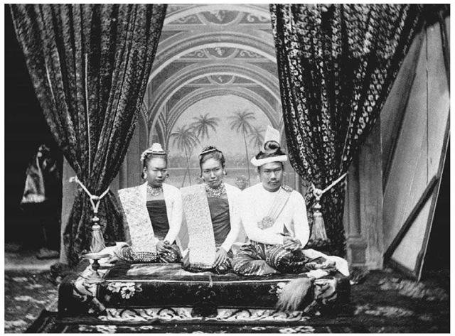 King Thibaw and Queen Supayalat of Burma. The king and queen of Burma are pictured along with the queen's sister at their palace in Mandalay, Burma, in the 1800s. Thibaw reigned from 1878 to 1885, when the British forced him from the throne. 