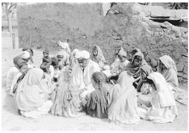 Outdoor Lesson in Punjab. A teacher for an Islamic school holds class outdoors in May 1933 in Taxila, Punjab.