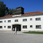 [EN] Dachau, Germany. Former concentration camp - The entrance gate with a guard tower. [SK] Dachau, Nemecko. Byvaly koncentracny tabor - Vstupna brana so straznou vezou.