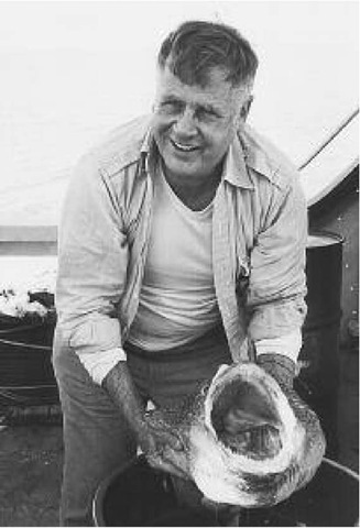 Harmon Craig aboard a Scripps Institution research vessel shows a fish that was accidentally speared by an arm of the ALVIN submersible during a dive 