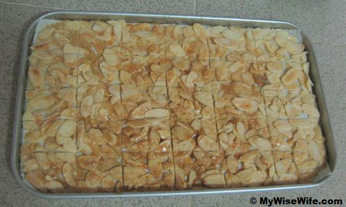 Golden brown caramel almond flakes are lined with knife Golden brown caramel almond flakes are lined with knife