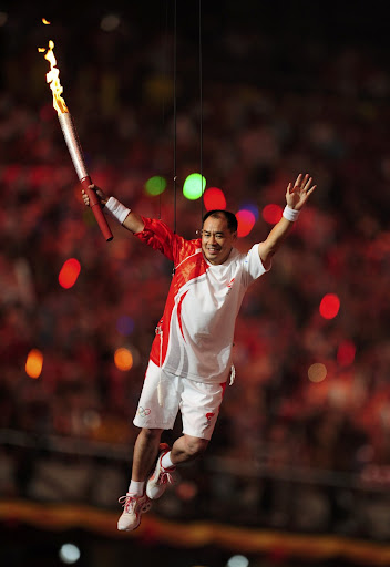  ... opening jpg former chinese gymnast li ning carries the olympic flame