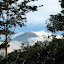 Gunung Wellirang smoking through the trees from PPLH