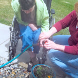 Alicia Bariekman hanging with her girls on a nice day. Helping Carey Walentiny with watering the plant.