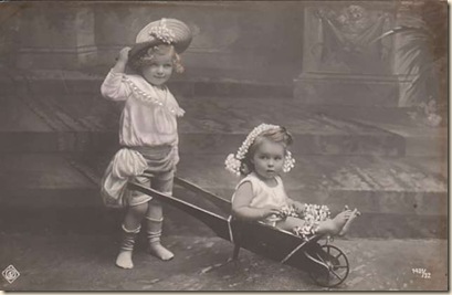 children getting a ride in a wheelbarrow