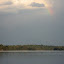 An afternoon rainbow breaks through the clouds