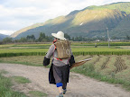 Near Shaxi farmer near Shaxi, walking home from work in the fields