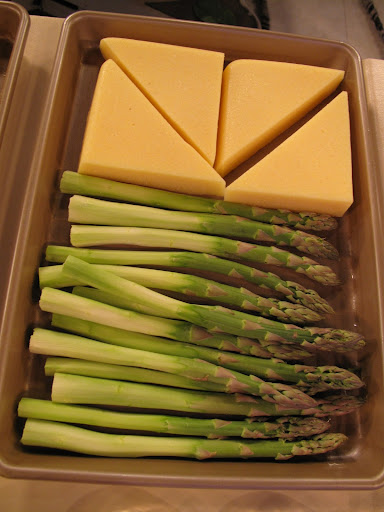 Polenta wedges and asparagus are ready to be broiled.