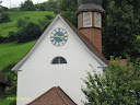 The clock on a white background of a building on the shore of Lake Lucerne in Switzerland - Thumbnail