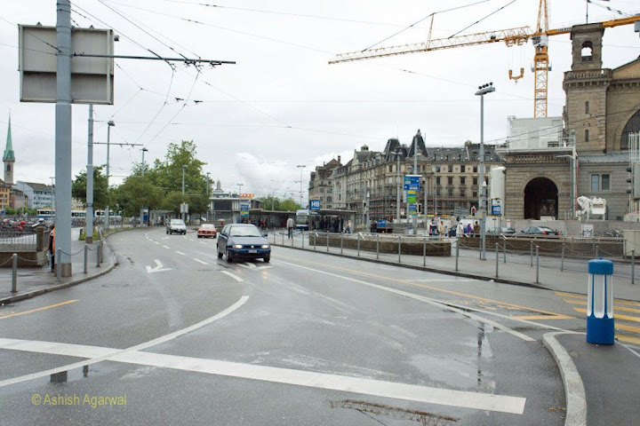 Streets in Zurich have large electric overheads because of the train and tram system