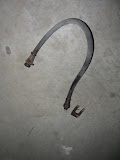 The rubber brake hose that connects the axle to the brake line that runs the length of the trailer frame. There was a stubborn U clip that finally came off with a lot of coaxing.