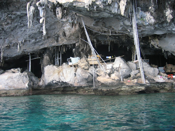 a cave with a boat and a boat