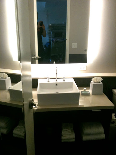 a mirror with a sink and a towel on the counter