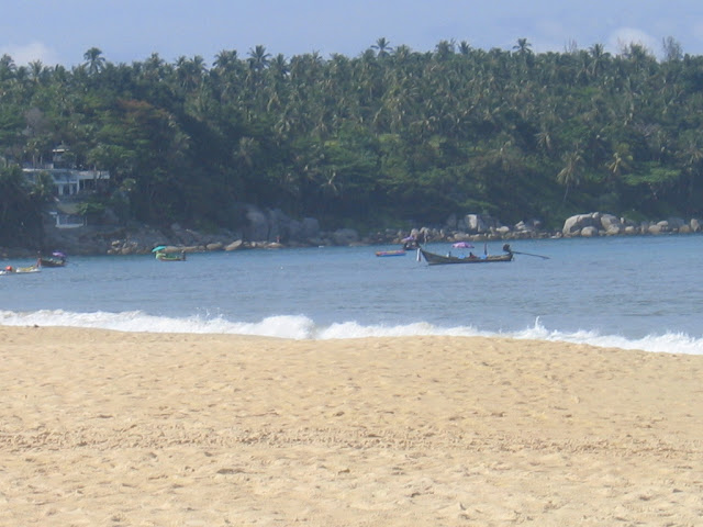 a beach with a boat in the water