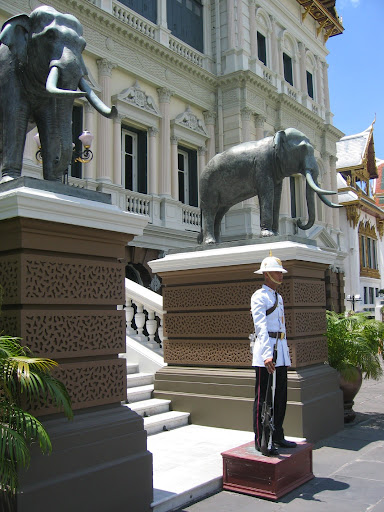 a man standing in front of a statue of an elephant