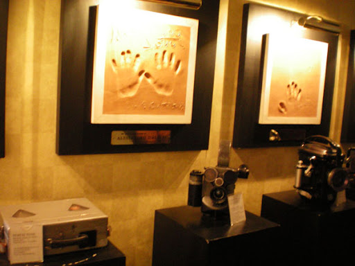 a framed picture of handprints and a camera