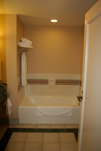 a bathtub with towels on the wall