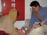 The happy couple and their plastic baby