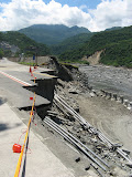 looking across the washed out road upriver from The Golden Shuai hotel