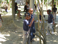 Swings made of rope.  Hopefully, a group will come down soon to make a playground.