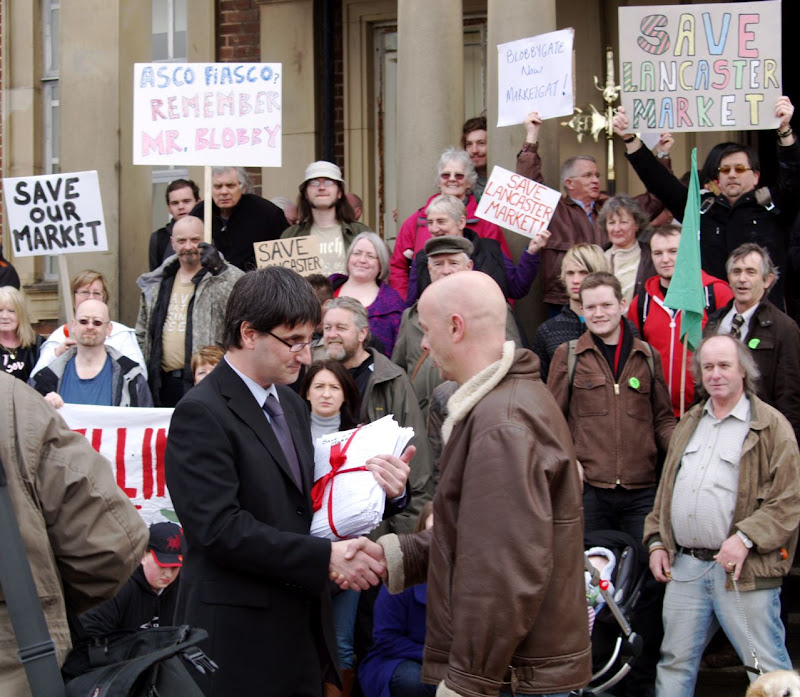 Peter Corker hands Stauart Langhorn the 13,000-signature strong petition protesting the proposed closure of Lancaster Market