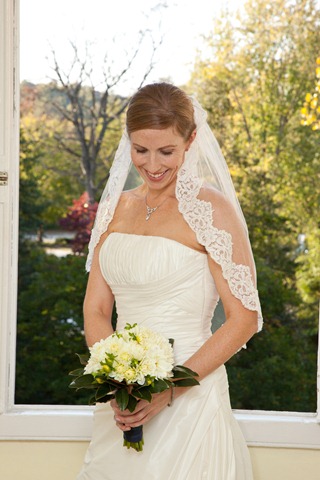 Katie carried a bouquet of white dahlias ringed with magnolia leaves