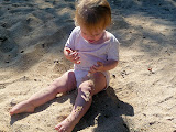 She was putting the sand on her legs. It was really cute