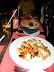 Pan fried kingclip with baby potatoes and vegetables, and in the background kid's meal: hot dog and chips.