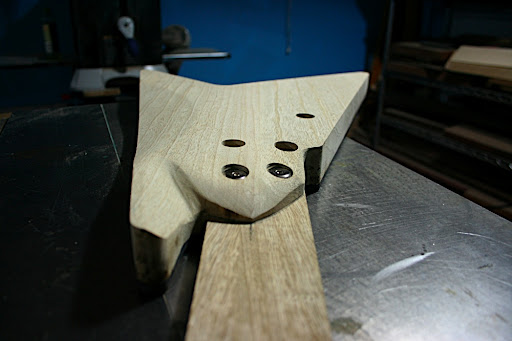 The heel has been shaved down and contoured. The bolts sit on 1/2" of wood on the heel, so the contours are just a bit thicker than that.