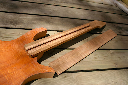 The roasted maple goes a bit more brown when finish is applied. I may apply a little bit of brown stain to the body to bring the tones more in line with each other.