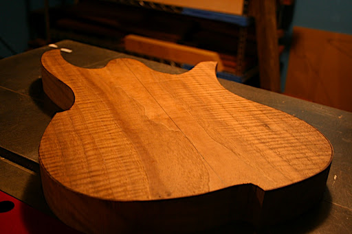 The body blank started out about 2 inches thick. It's been surfaced down to a more modest thickness, and the top will be carved to a 16-inch radius.