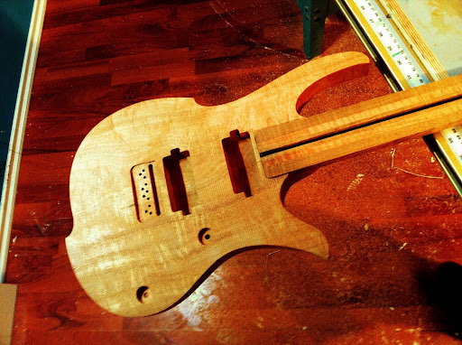 The neck-to-body joint is tight enough that there's sufficient friction to allow the body's weight to be held up by just neck press-fitting the neck into the pocket. No glue or fastneners are holding the two together at this point.