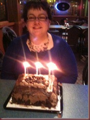 posing in front of cake
