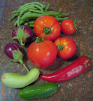 Part of one day's harvest - bush and pole beans, eggplant, supertasty and early girl toms, carmen pepper, cucumbers pearl and tendergreen.