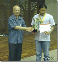 Ian Udani receives trophy from IIUM's Rector, Prof.Syed Arabi