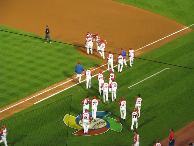 Jesus Feliciano (#23) joins his Puerto Rican teammates (Beltran, Delgado, Cora, Pedro Feliciano) in celebrating the mercy rule win over the USA