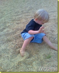 Aaron in the sand at playground
