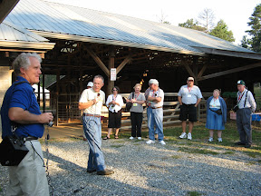 people listening to speaker at farm