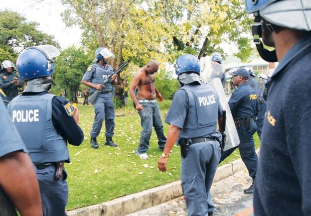 [Tatane Andries Shot at close range by police Ficksburg collapses and dies Pic WillemvanderBergVolksblad[4].jpg]