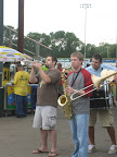 Photo: Rob and Jeff play their horns for the Duck Blind crowd at the Duck Pond.