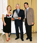 Sandy Riegler presenting Laurence Factor with Commodore's Trophy for dedication to the Club. Far right Stanley Saffer, Commodore