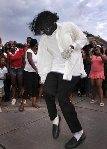 DETROIT - JUNE 25: A man dressed as Michael Jackson dances for the fans who turned out to pay their respects at the Motown Historical Museum "Hitsville U.S.A" June 25, 2009 in Detroit, Michigan. Jackson, 50, the iconic pop star, died after going into cardiac arrest in a hospital today in Los Angeles, California. (Photo by Bill Pugliano/Getty Images)