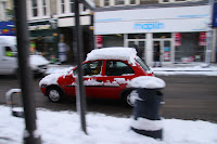 A half-hearted attempt to remove the snow from the car