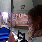 Safe under the umbrella in the thunder and rain, Venice canal.